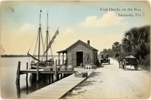 Hand-tinted postcard-style illustration of the fish docks on Sarasota Bay, Sarasota, Florida, in the style of about 1910